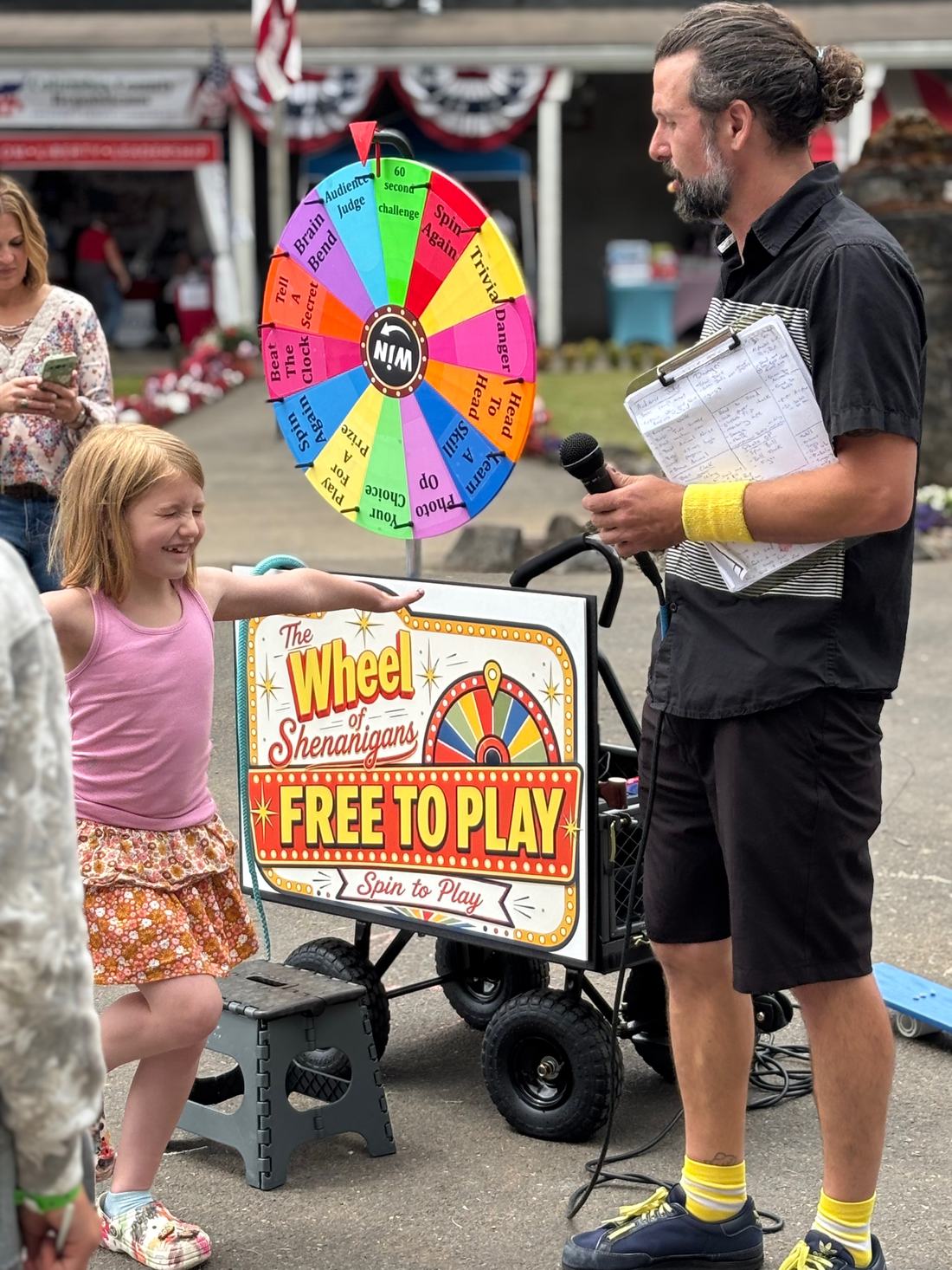 A young girl reaching out to spin the wheel while Matt Baker hosts